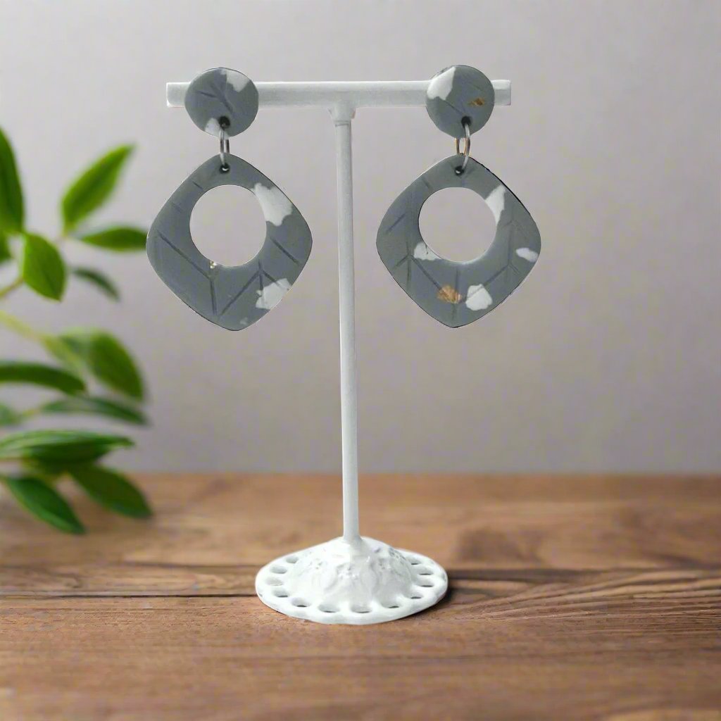 polymer clay earring on display stand