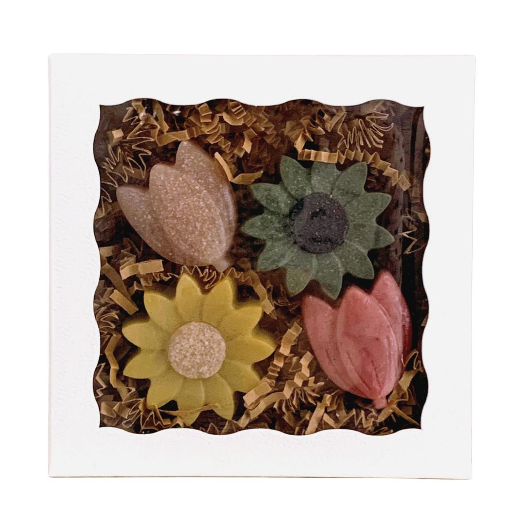 a box of 4 floral goat milk hand soaps on a white surface